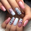 A Complete Set of 24 Short Square Fake Nails Featuring a Pink And Black-And-White Zebra Stripe Design, Including One Jelly Glue And One File, Perfect for Parties, Dancing, And Everyday Wear; They Are Removable And Reusable.